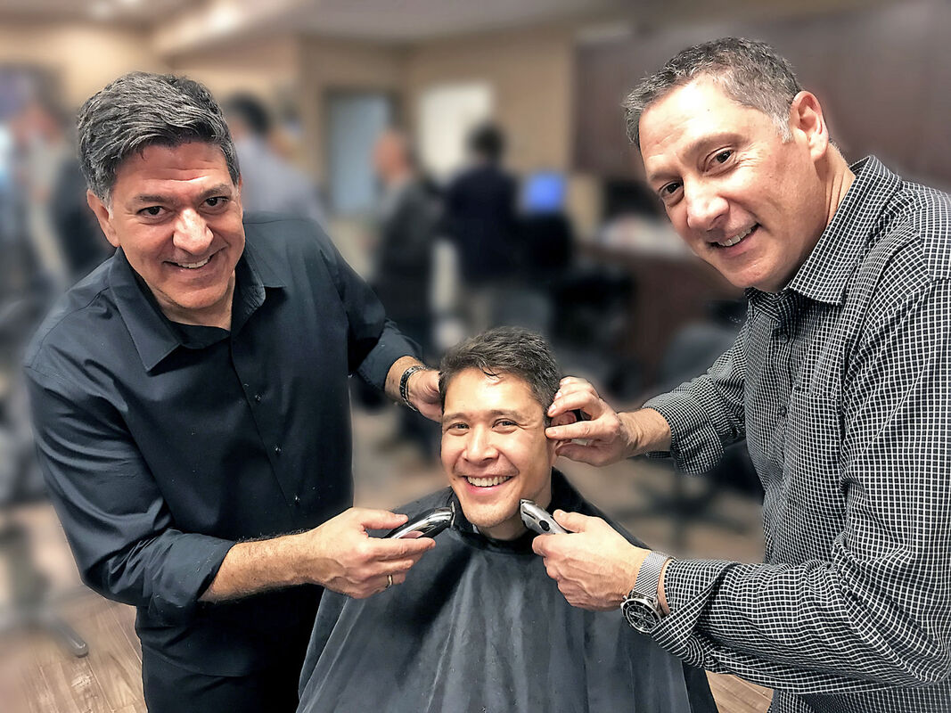 Sam and Tony Caruso with a client