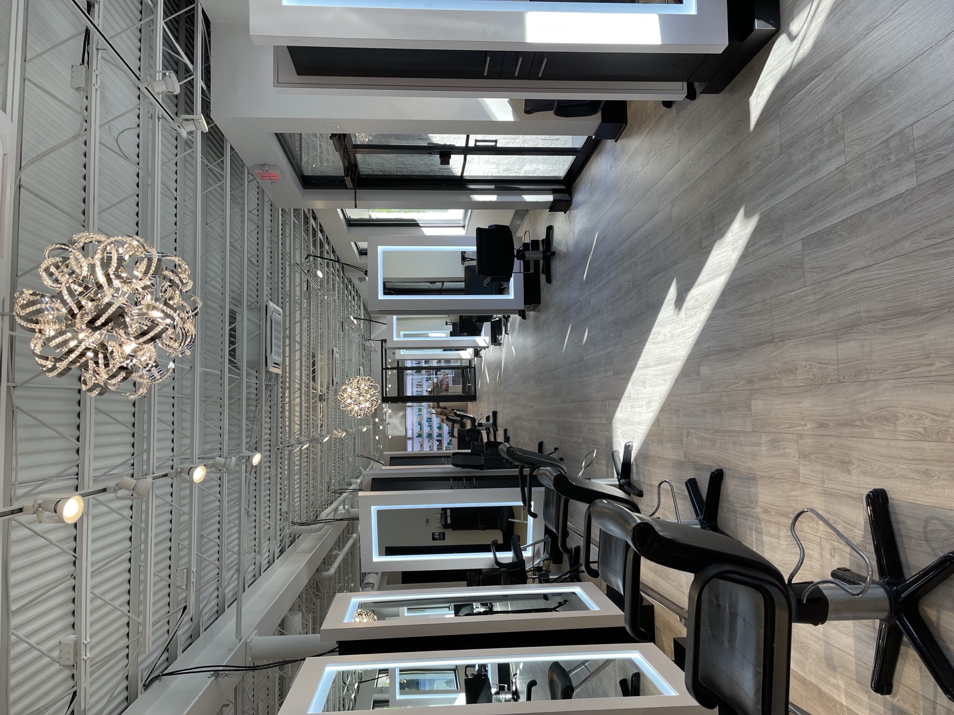 Caruso salon interior — chandeliers and styling stations