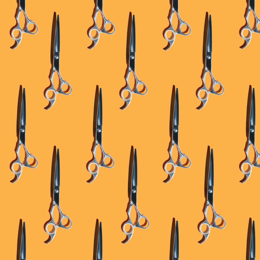 Styling shears arranged on a gold background